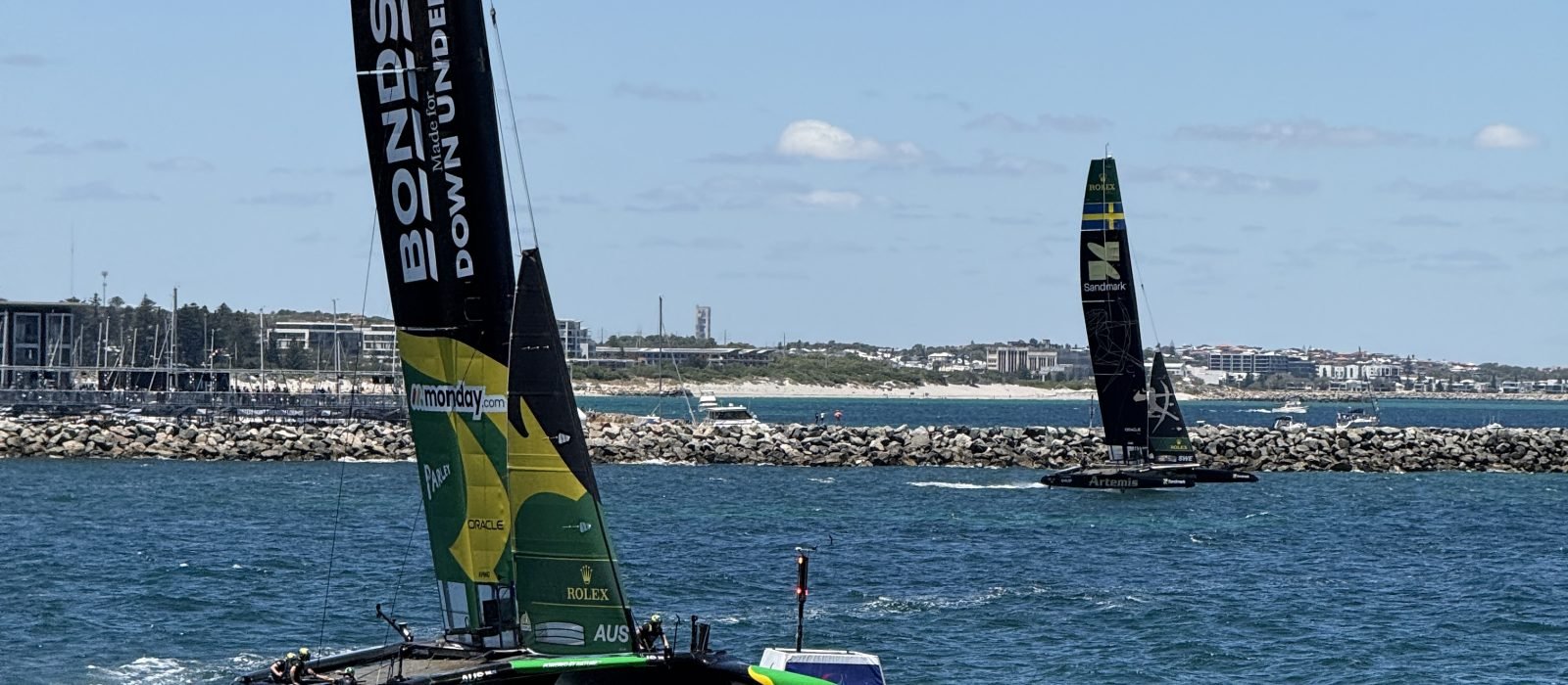 The Australian Bonds Flying Roos F50 foiling at speed with its wingsail raked, racing at the 2026 Perth Sail Grand Prix