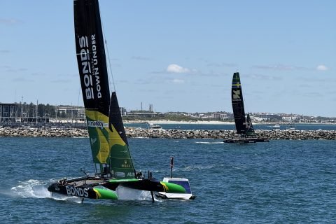 The Australian Bonds Flying Roos F50 foiling at speed with its wingsail raked, racing at the 2026 Perth Sail Grand Prix