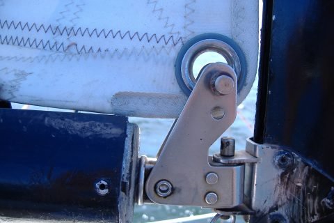 A gooseneck swivel connection holding the boom to the mast on a typical small en:yacht