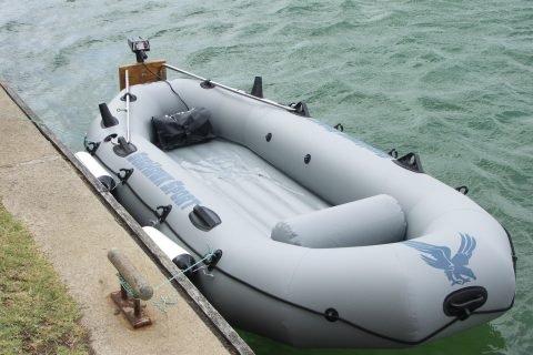 PVC inflatable boat with small electric trolling outboard motor